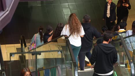 People-taking-the-escalators-down-at-Melbourne-Central-Station,-a-shopping-and-commercial-precinct-in-downtown-area,-showcasing-the-hustle-and-bustle-of-urban-lifestyle