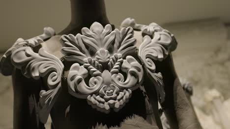 Close-up-of-sculpted-armor-design-showcased-at-a-high-end-fashion-show