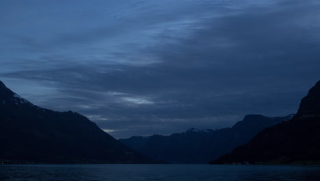 Timelapse-of-fast-moving-clouds-during-the-blue-hour-over-a-fjord-in-Norway