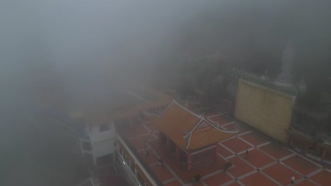 Drone-Vuela-A-Través-De-La-Niebla-Cerca-De-Las-Tierras-Altas-De-Genting-En-Malasia:-Se-Pueden-Ver-Templos-Y-Buda