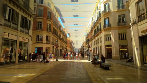 Bustling-pedestrian-street-in-Malaga's-city-center-with-people-walking-and-historic-buildings-around