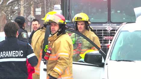 Paramedics,-police-officers,-and-firefighters-respond-to-incident-gathered-together-in-the-snow