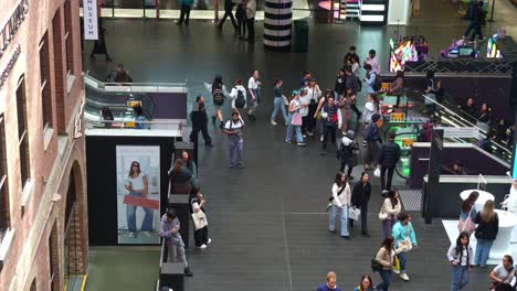 Shoppers-and-commuters-taking-the-escalators-up-and-down-at-Melbourne-Central-Station,-a-shopping-and-commercial-precinct-in-downtown-area,-showcasing-the-hustle-and-bustle-of-urban-lifestyle