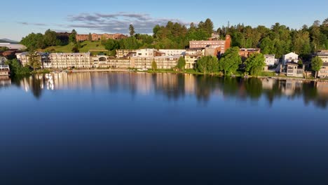 Aerial-approaching-shot-of-hotels-on-Mirror-Lake-in-Lake-Placid,-New-York