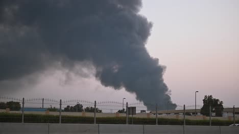 The-smoke-rising-high-into-the-sky-from-a-huge-fire-that-took-place-in-an-industrial-area-in-Sharjah,-United-Arab-Emirates