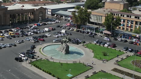 Aerial-orbits-equestrian-statue-and-traffic-in-Yerevan-plaza,-Armenia