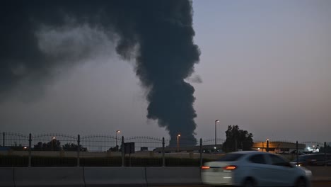 The-smoke-rising-high-into-the-sky-from-a-huge-fire-that-took-place-in-an-industrial-area-in-Sharjah,-United-Arab-Emirates