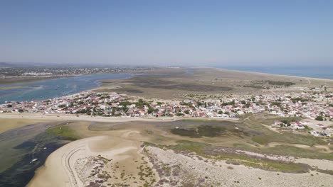 Aerial-establishing-dolly-of-small-coastal-town-of-Armona-Island,-Olhao-Portugal-with-sandy-beach