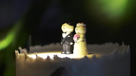 Close-up-shot-of-wedding-cake-with-cute-bride-and-groom-dolls