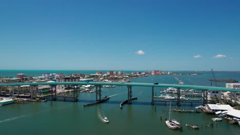 Beautiful-drone-shot-of-the-Fort-Myers-Beach-bridge,-homes-and-businesses