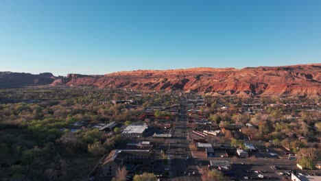 Drone-shot-panning-to-the-left-over-Moab,-Utah-on-a-sunny-evening