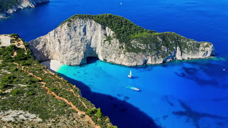 Famous-Navagio-shipwreck-beach-in-Greece,-aerial-dolly-out-sunny-summer-day