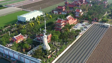 Aerial-drone-flyover-and-around-the-Chifa-Matsu-Temple-in-the-middle-of-agricultural-fields,-a-sacred-site-dedicated-to-goddess-of-sea,-a-blend-of-cultural-heritage-and-rural-landscape,-Yunlin,-Taiwan