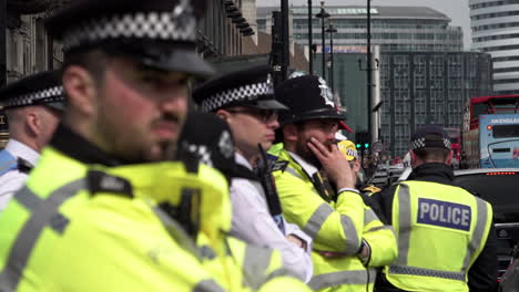 A-Metropolitan-police-officer-unit-stands-in-line-and-monitors-a-public-order-event-on-Parliament-Square