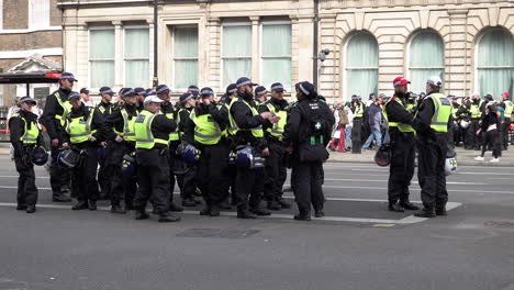 A-Metropolitan-Territorial-Support-Group-police-officer-unit-with-Nato-helmets-on-their-belts-stand-in-formation-during-a-public-order-event