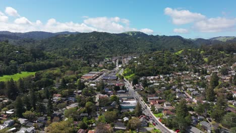 High-elevation-drone-shot-flying-over-downtown-Fairfax,-California-on-a-busy-day