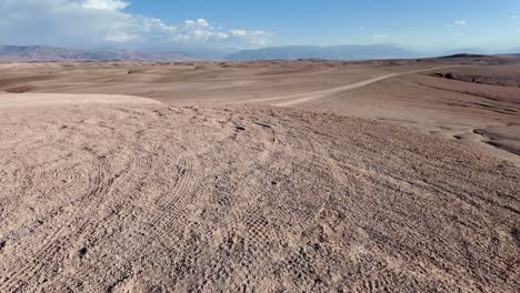 Walking-in-the-Agafay-desert-in-North-Africa,-Morocco,-empty-land,-clear-sky