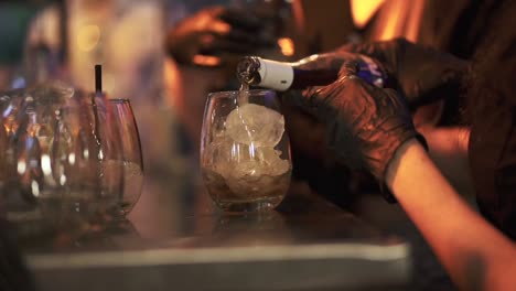 Pouring-alcohol-drink-into-glasses-on-the-table-at-event