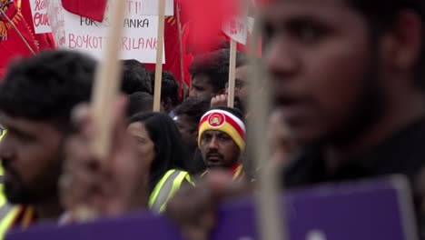 Protestors-hold-placards-and-the-red-national-Tamil-Eelam-flag-during-a-protest-marking-the-15th-anniversary-of-the-death-rebel-Tamil-Tiger-leader-Velupillai-Prabhakaran