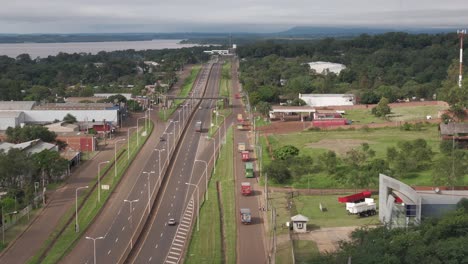 Group-of-trucks-traveling-in-convoy-on-an-avenue-in-Posadas,-Misiones,-Argentina