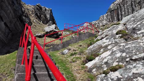 Ireland-Epic-locations-red-railings,-steps-to-Sheeps-Head-Lighthouse-in-West-Cork-on-a-perfect-day