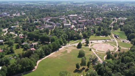 A-stunning-aerial-view-of-Sigulda-city,-highlighting-its-integration-with-lush-green-spaces-and-natural-landscapes