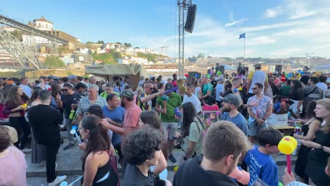 Scene-of-happy-people-having-a-great-time-drinking,-partying,-and-pounding-the-heads-of-everyone-with-plastic-hammers-on-the-street-during-the-celebration-of-the-São-João-do-Porto,-Portugal