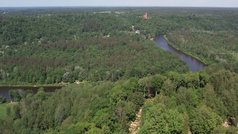 A-stunning-aerial-view-of-Sigulda-city,-highlighting-its-integration-with-lush-green-spaces-and-natural-landscapes