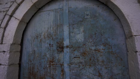 Locked-Door-for-Years-in-a-Village-with-Stone-Houses,-Symbolizing-Residents-Leaving-Their-Homeland,-Concept-of-Emigration