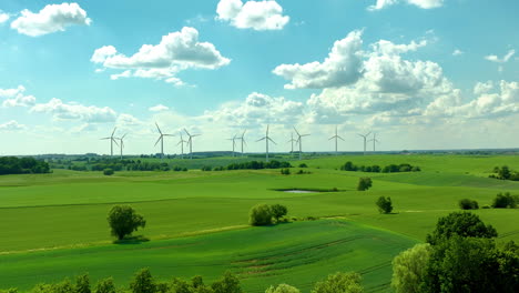Expansive-green-farmland-with-wind-turbines-in-the-distance-and-a-partly-cloudy-sky