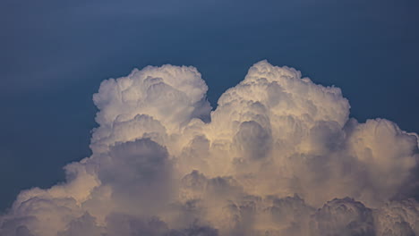 Timelapse-close-up-of-cloud-formation-with-a-soft-light-on-a-dark-blue-sky