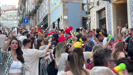 Tourists-and-locals-are-having-a-great-time-pounding-the-heads-of-everyone-with-plastic-hammers-on-the-street-during-the-celebration-of-the-São-João-do-Porto,-Portugal