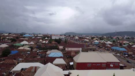 Drone-shot-rising-over-Abuja-city-in-Nigeria-with-cars-driving-on-road