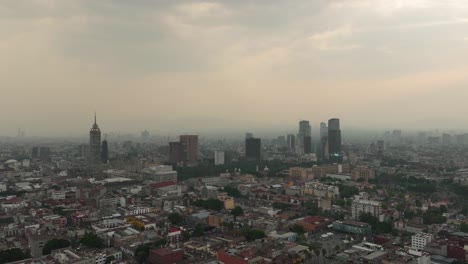 Hyperlapse-of-a-polluted-afternoon-in-the-Historic-Center-of-Mexico-City,-Mexico,-showcasing-the-famous-Torre-Latinoamericana,-along-with-other-notable-buildings