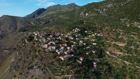 Scenic-Village-of-Qeparo-with-Stone-Houses-Built-on-High-Cliffs-and-Mountain-Background-in-the-Albanian-Riviera