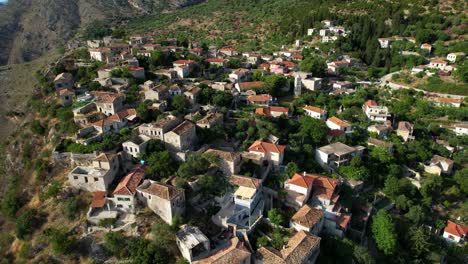 Medieval-Village-with-Stone-Houses-Built-on-High-Cliffs-with-Mountain-Background-Overlooking-the-Ionian-Sea-in-the-Albanian-Riviera