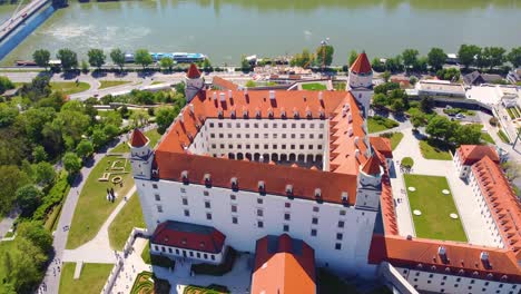 Bratislava-Castle-overlooking-river-in-Slovakia,-aerial-high-angle-dolly