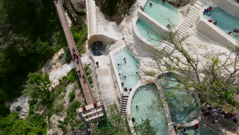 Tourists-relax-and-enjoy-a-day-at-the-hot-springs-of-Grutas-Tolantongo,-Mexico