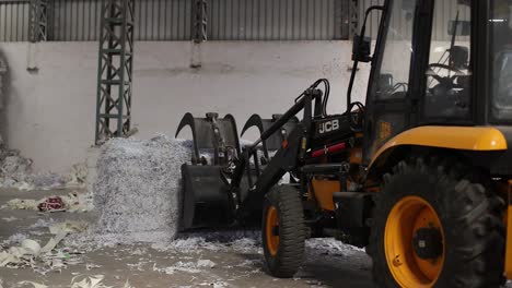 Wasteage-waste-is-picked-up-by-jcb-and-fed-through-convert-inside-big-recycle-bean-machine