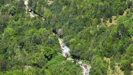 distant-aerial-view-with-zoom,-rural-road-through-the-forest