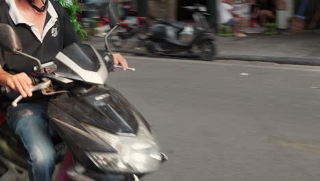 Ein-Mann-Transportiert-Grünpflanzen-Auf-Einem-Motorroller-Durch-Das-Historische-O-Quan-Chu-O-Ng-Tor-In-Der-Altstadt-Von-Hanoi,-Vietnam