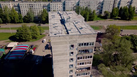 Aerial-footage-of-a-communistic-prefab-panel-apartment-block,-highlighting-windows-and-rooftop-details