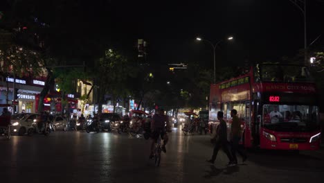 Imágenes-En-Cámara-Lenta-De-Una-Bulliciosa-Calle-En-El-Casco-Antiguo-De-Hanoi,-Vietnam,-Que-Capturan-La-Vida-De-La-Ciudad-Y-Las-Vibrantes-Actividades-Nocturnas.