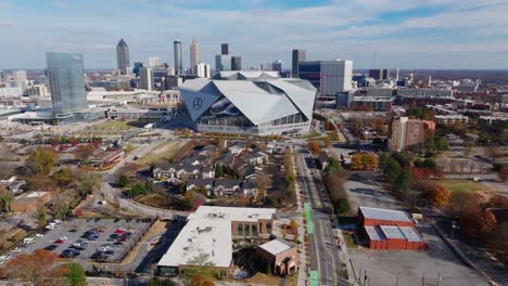 Drone-shot-of-Mercedes-Benz-Stadium-surrounded-by-office-buildings-in-autumn