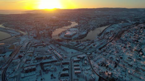 Aerial-Shot-Over-Trondheim,-Norway-in-Winter-at-Snowy-Sunset