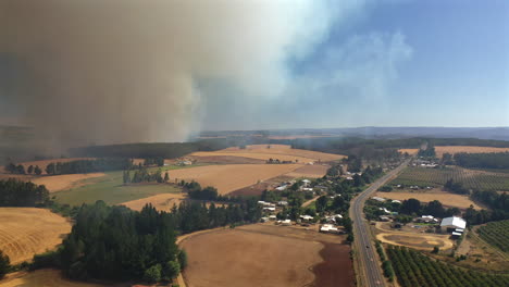 Izquierda-Panorámica-Aérea-Incendio-Forestal-Enorme-Humo-Marrón-Desastre-Ecológico-Paisaje-Seco-Araucania-Chile-Cielo-Azul-Verano