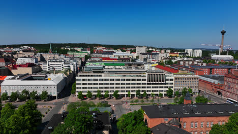 Aerial-tracking-shot-of-the-cityscape-of-Tampere,-sunny,-summer-day-in-Finland