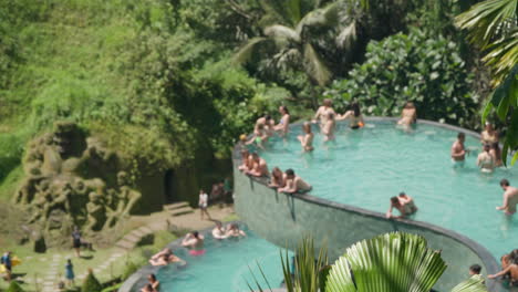 Tourists-Enjoying-Infinity-Swimming-Pool-At-Cretya-Ubud-By-Alas-Harum-In-Bali,-Indonesia---Dolly-Shot