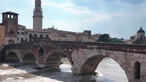 Ponte-Pietra-arched-bridge-with-red-bricks-and-panorama-of-the-old-city