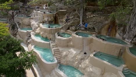 180-degrees-orbit-aerial-of-Grutas-de-Tolantongo-hot-springs-pools,-Mexico